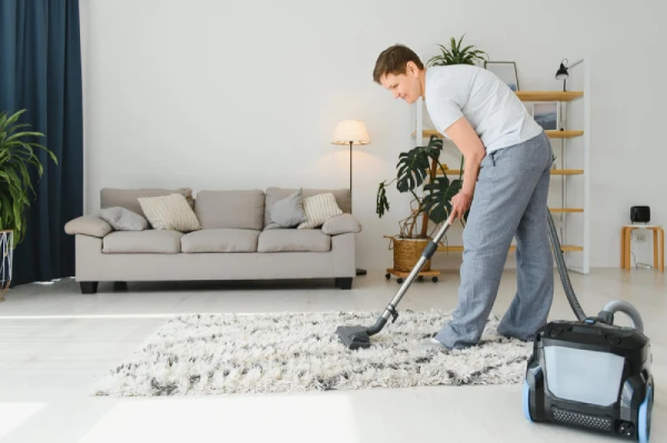 A man handling carpet cleaning with vacuum machine